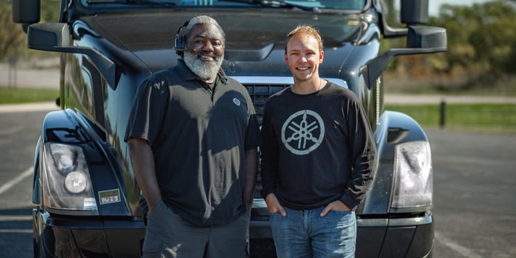 Driver-and-Fleet-Manager-Smiling-in-Front-of-Truck